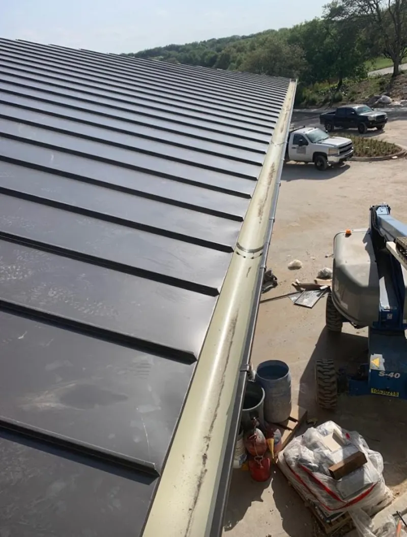 Standing seam panel and gutter detail on a metal roofing jobsite in Great Neck